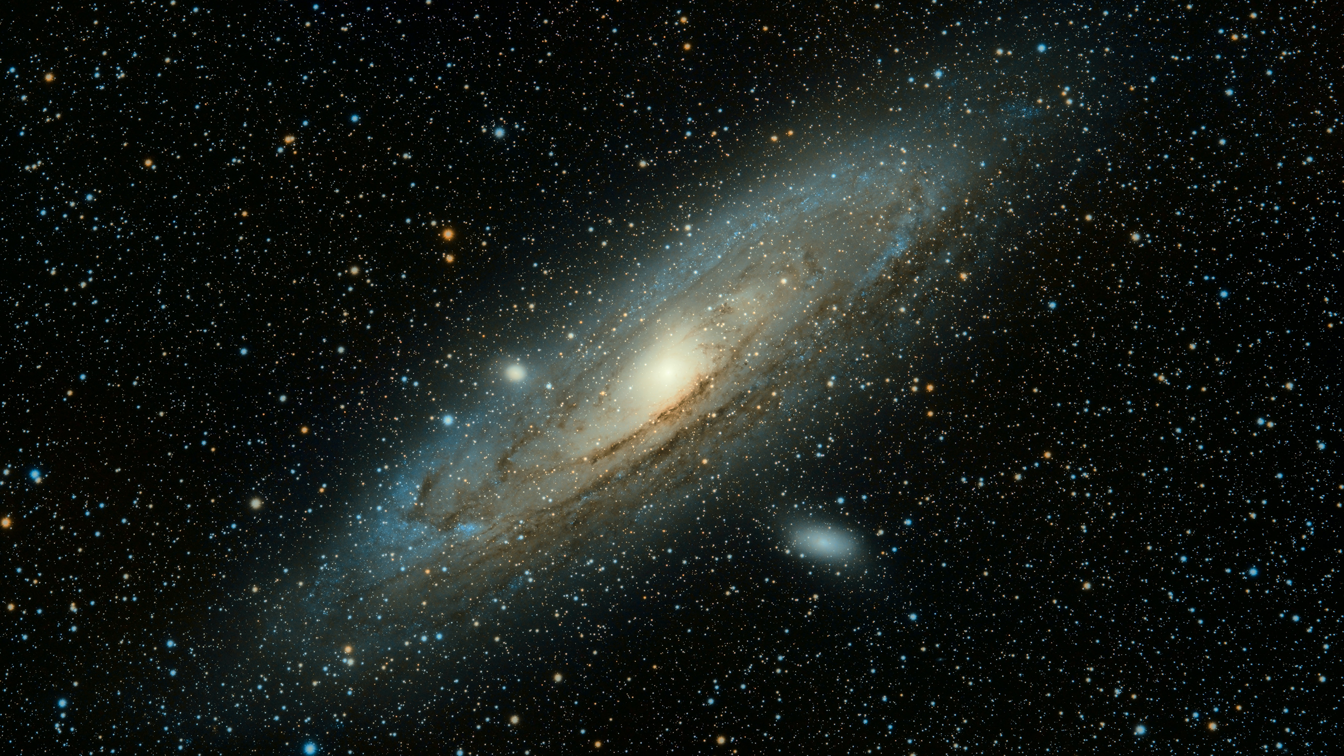 A large gray galaxy with stars in the background